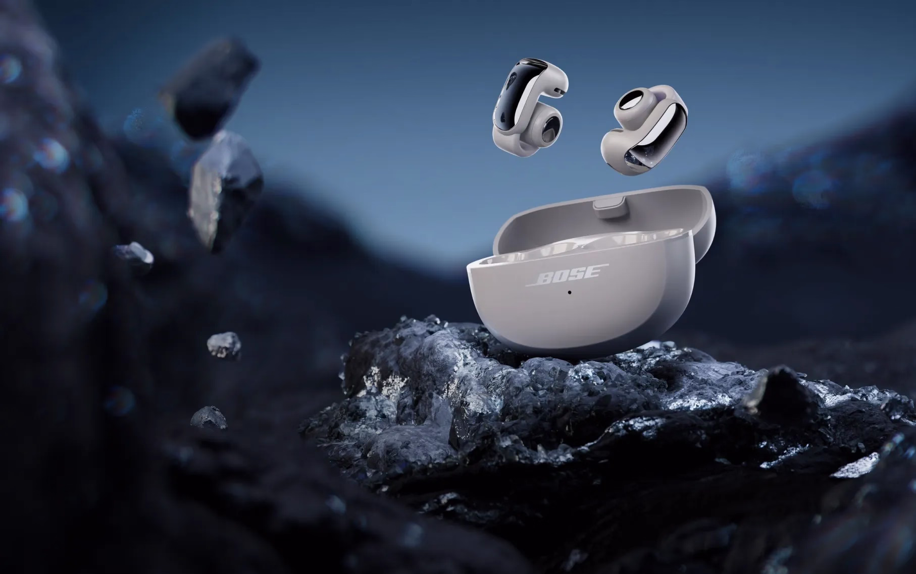 Bose Ultra Open Earbuds and their charging case in Moonlight Grey.