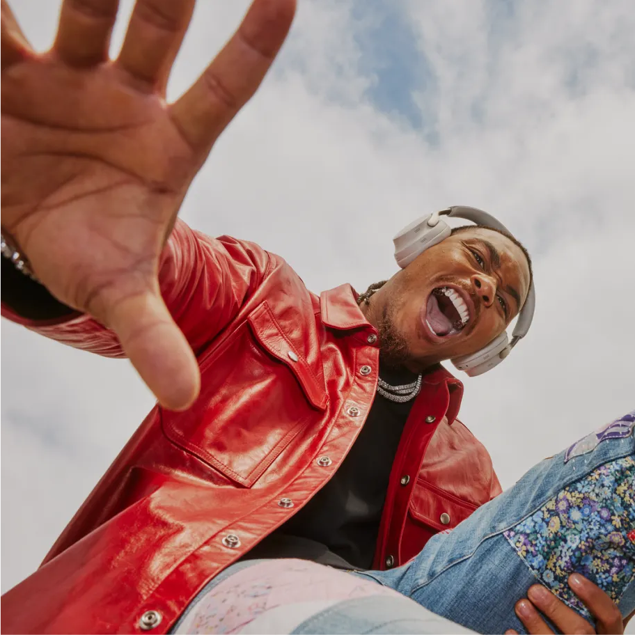 Young man wearing Bose QuietComfort Ultra Headphones outside.